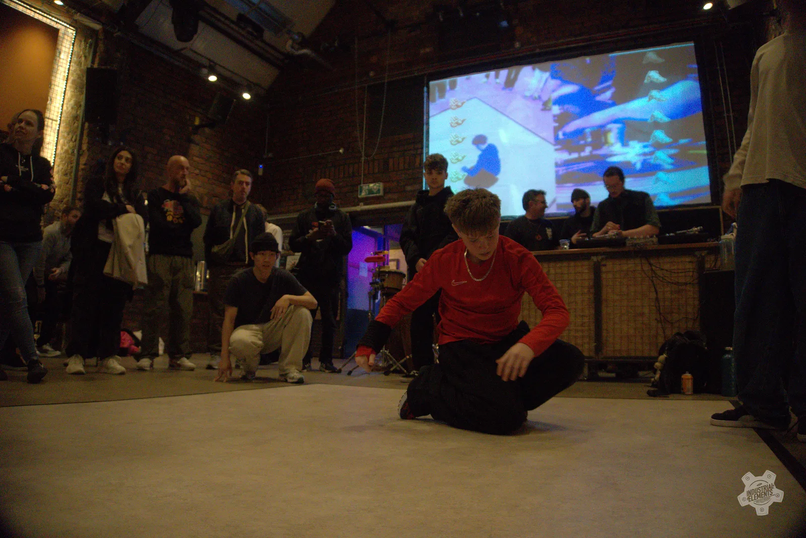 Audience gathered around a breaking floor at an Industrial Elements event